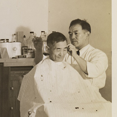 Men at the barbershop at the Amache concentration camp.